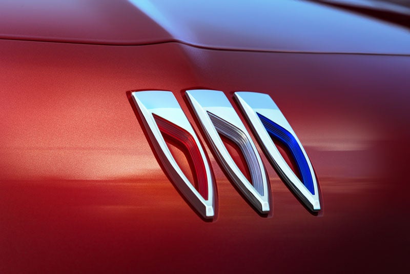 closeup view of buick logo of red car