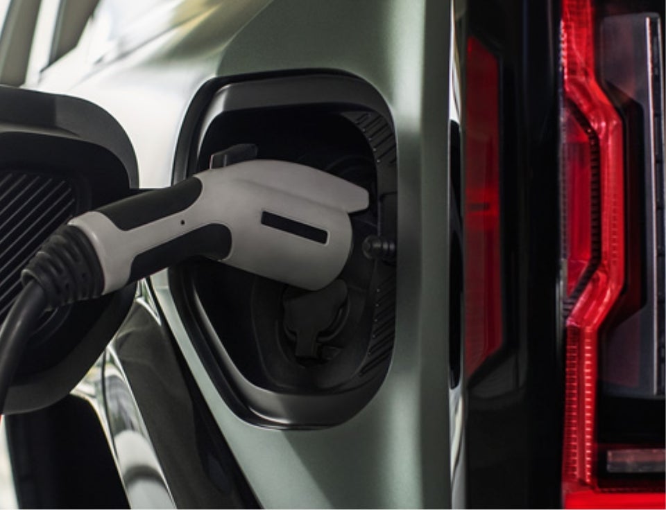 Close up of charging port with charger plugged in on a GMC Hummer EV SUV - Gaffney Buick GMC in Gaffney SC